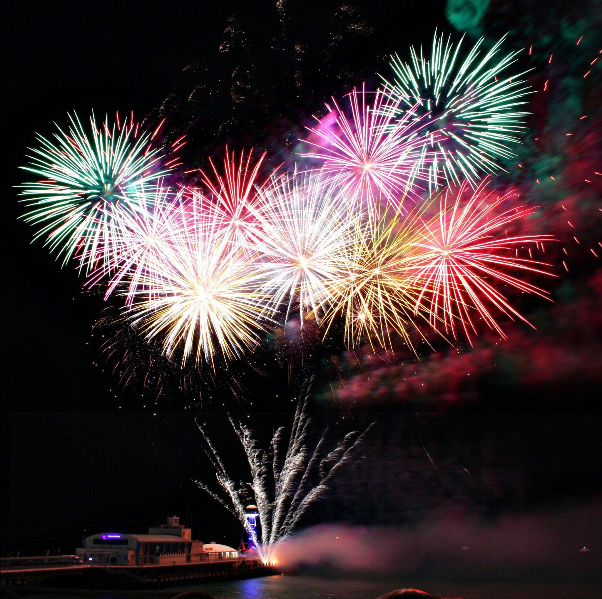 Spectacular fireworks display lighting up the night sky over Bournemouth Pier, England.